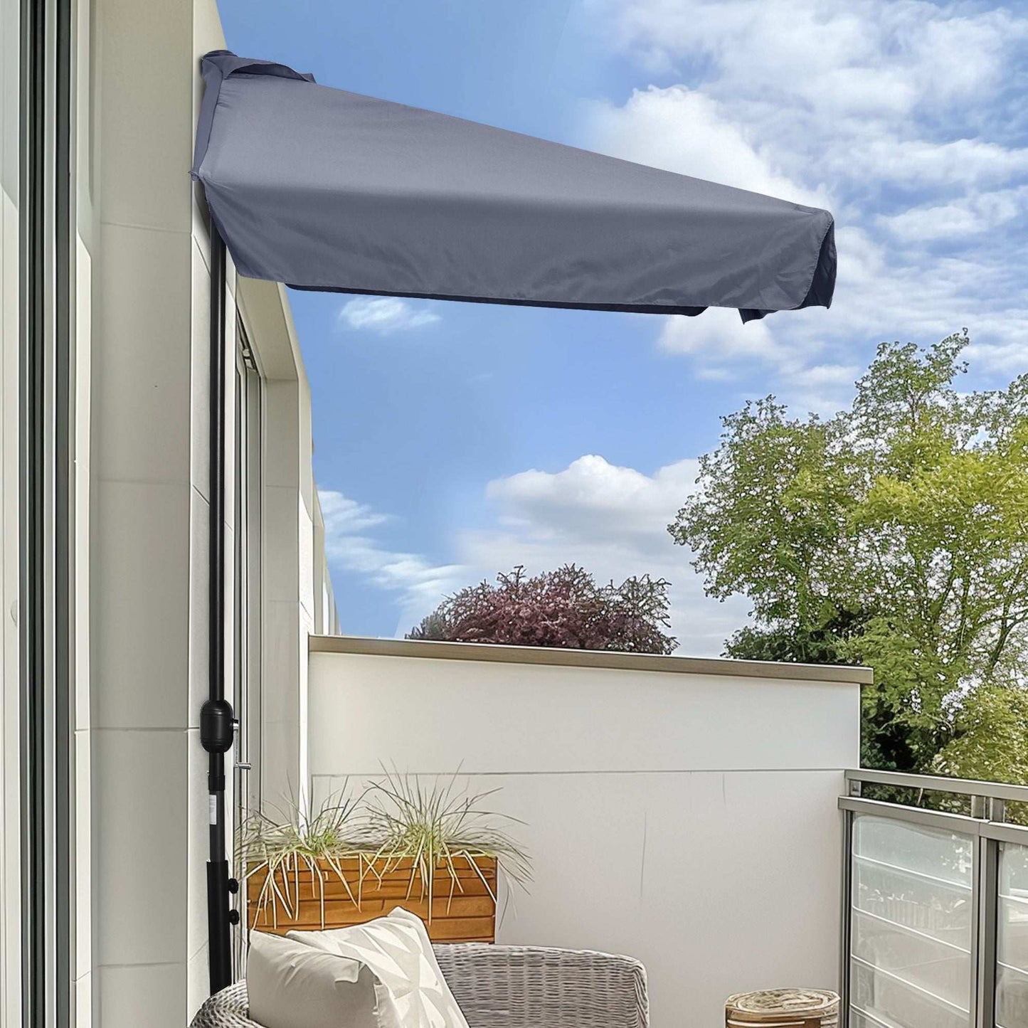 Balcony with a retractable awning, plants, and a clear sky.