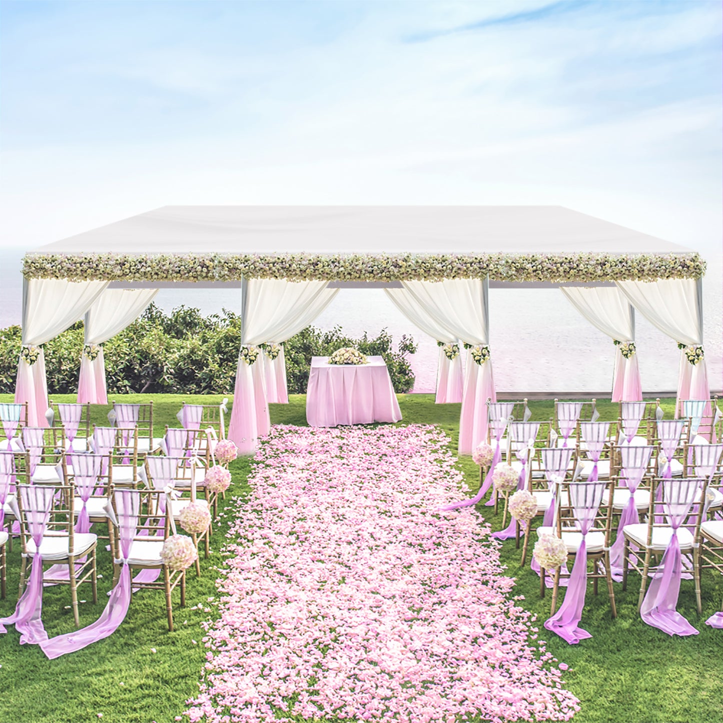 Decorated outdoor wedding setup with pink floral arrangements, tablecloths, and chair covers.