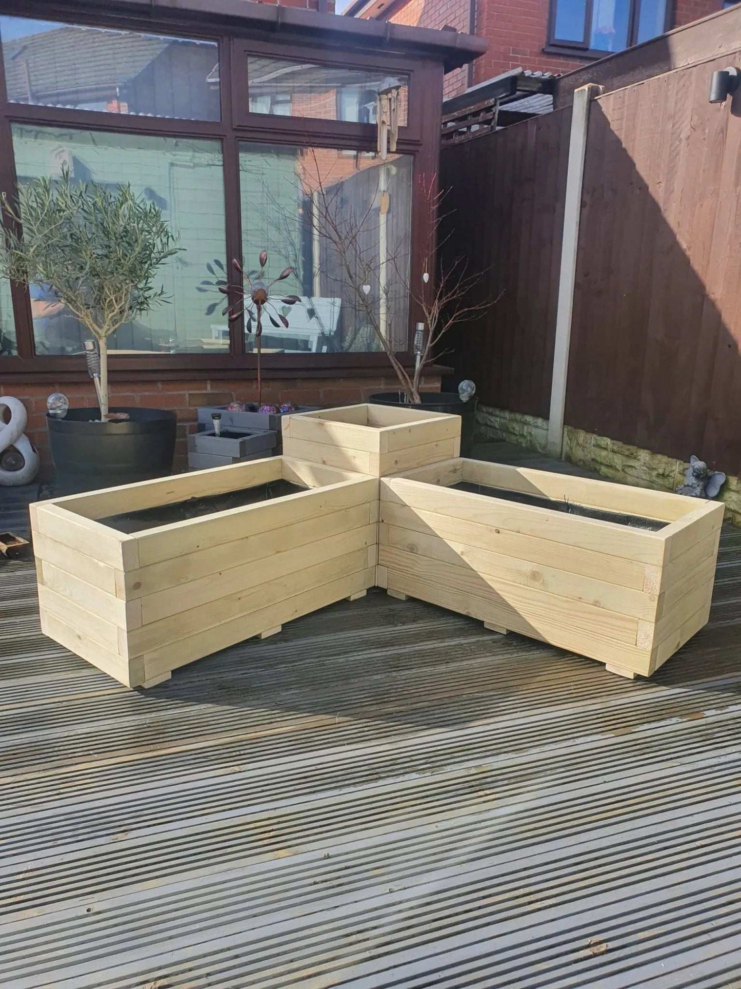 Large Corner Wooden Treated Garden Planter on decking with tree