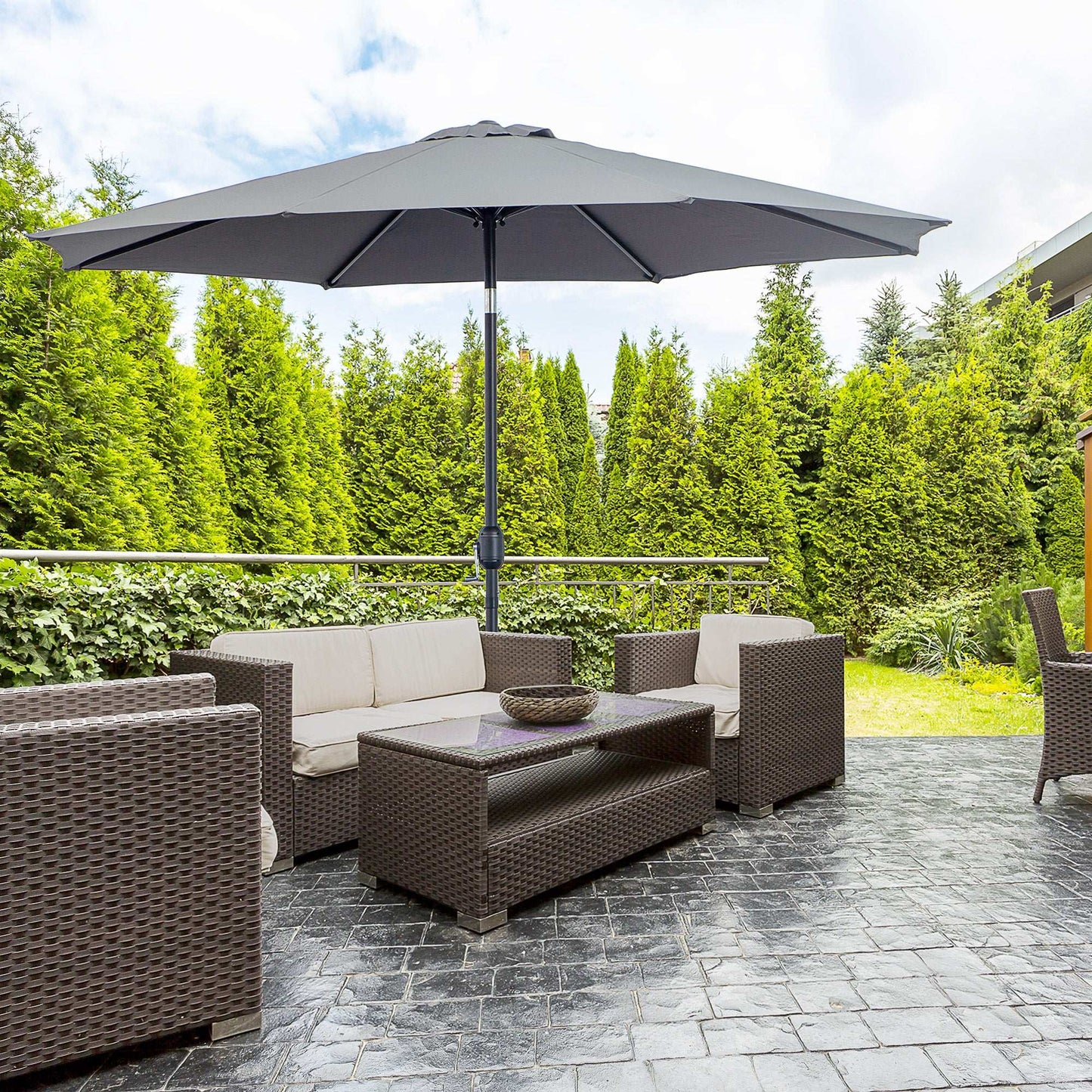 Outdoor patio set with furniture and umbrella on a stone patio