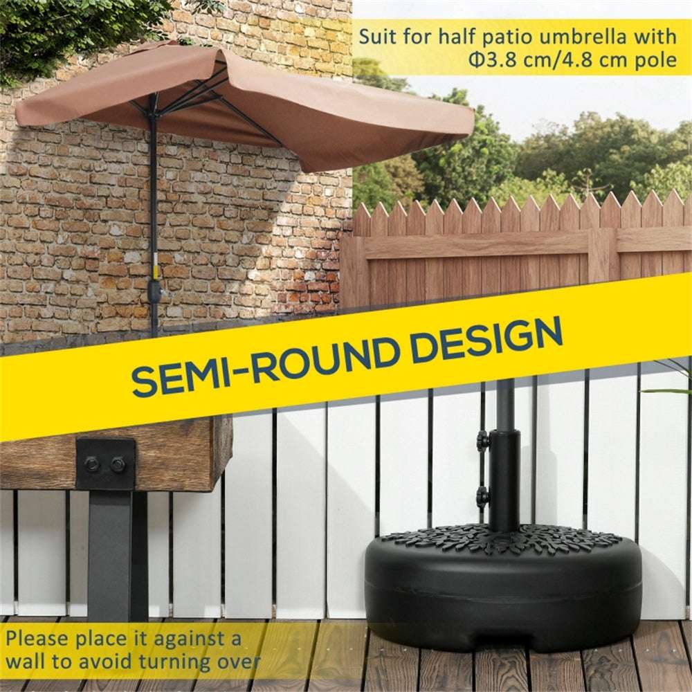 Semi-round patio umbrella with base on a wooden deck against a stone wall.
