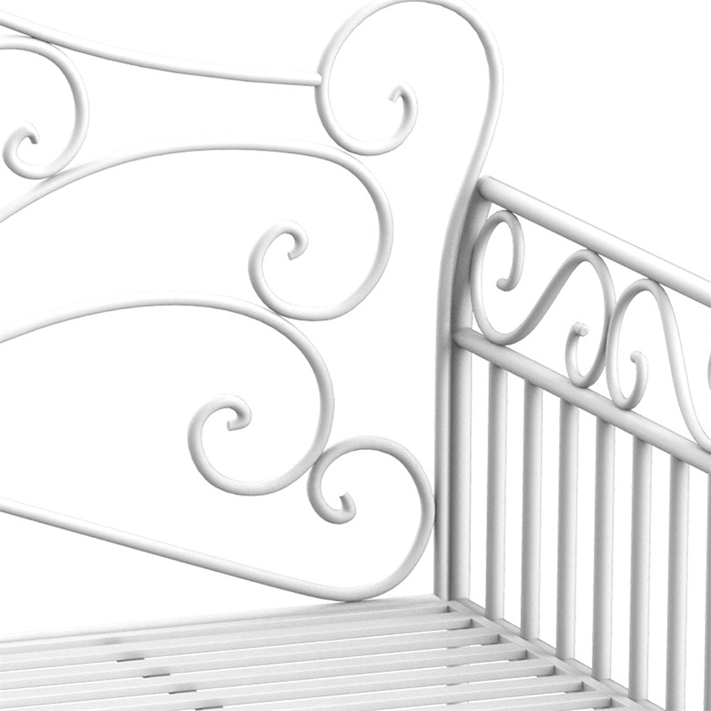 White metal crib with decorative scrollwork on a white background