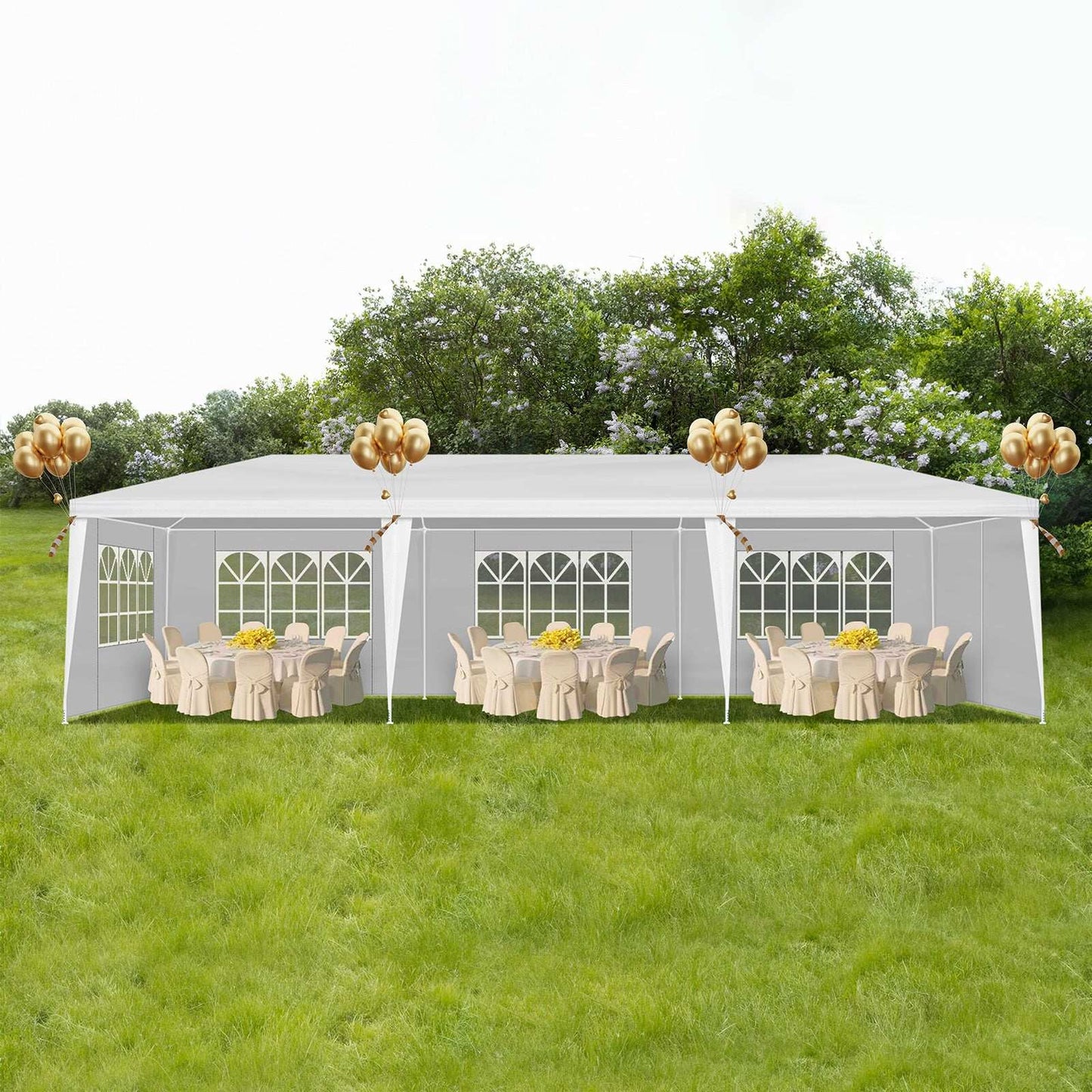 White party tent with tables and chairs under a clear sky