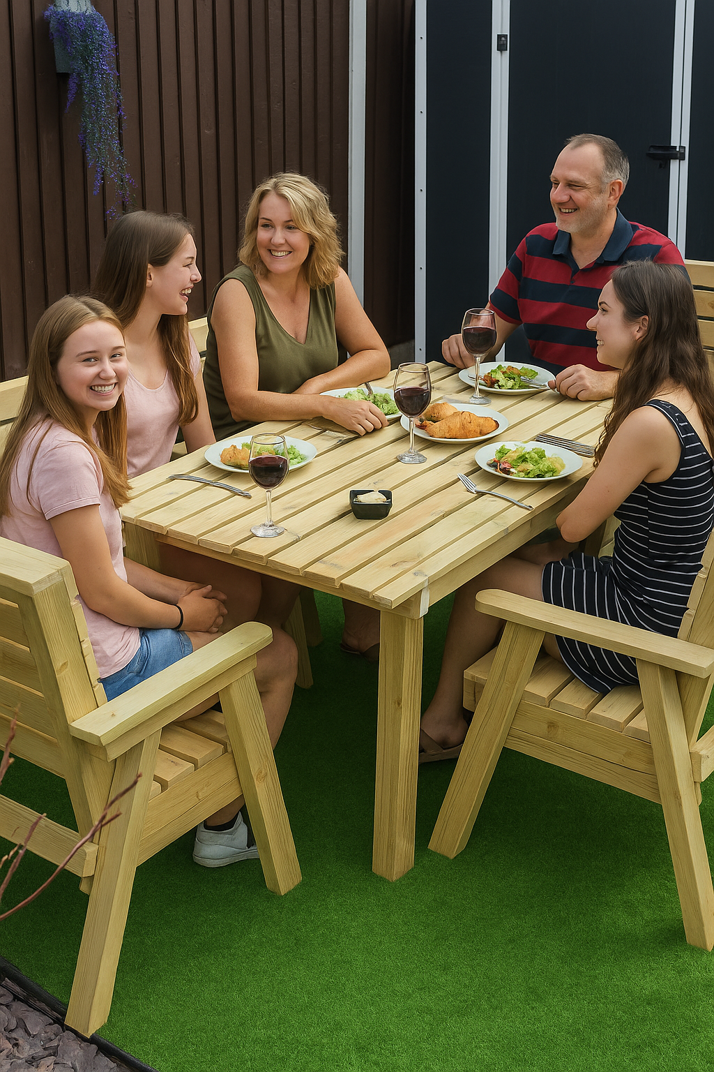 Family of four sitting around a wooden table outdoors, enjoying a meal.