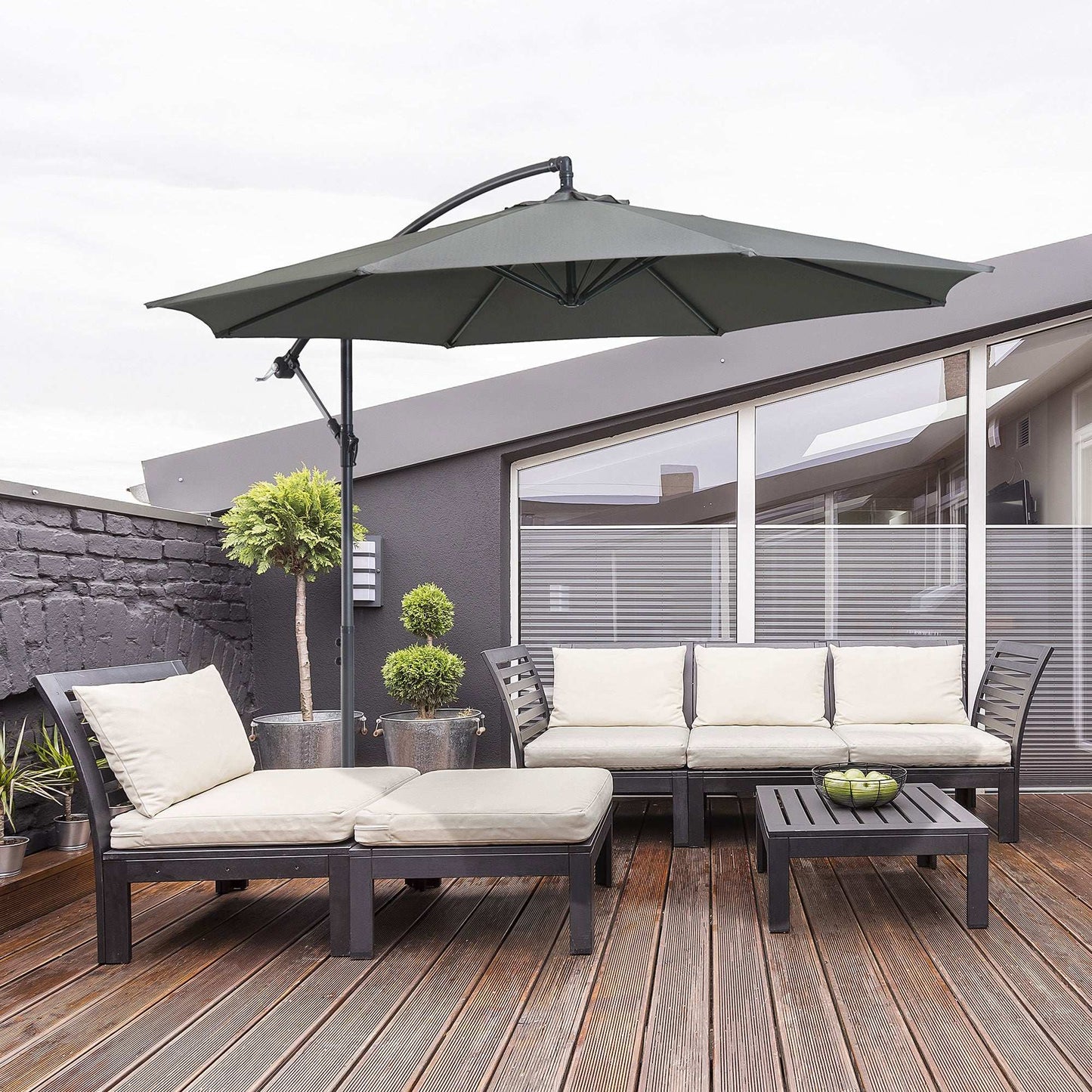 Outdoor patio set with umbrella, table, and chairs on a wooden deck.