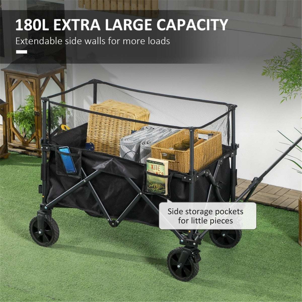 Black folding cart with extendable side walls and storage pockets on a grassy area.
