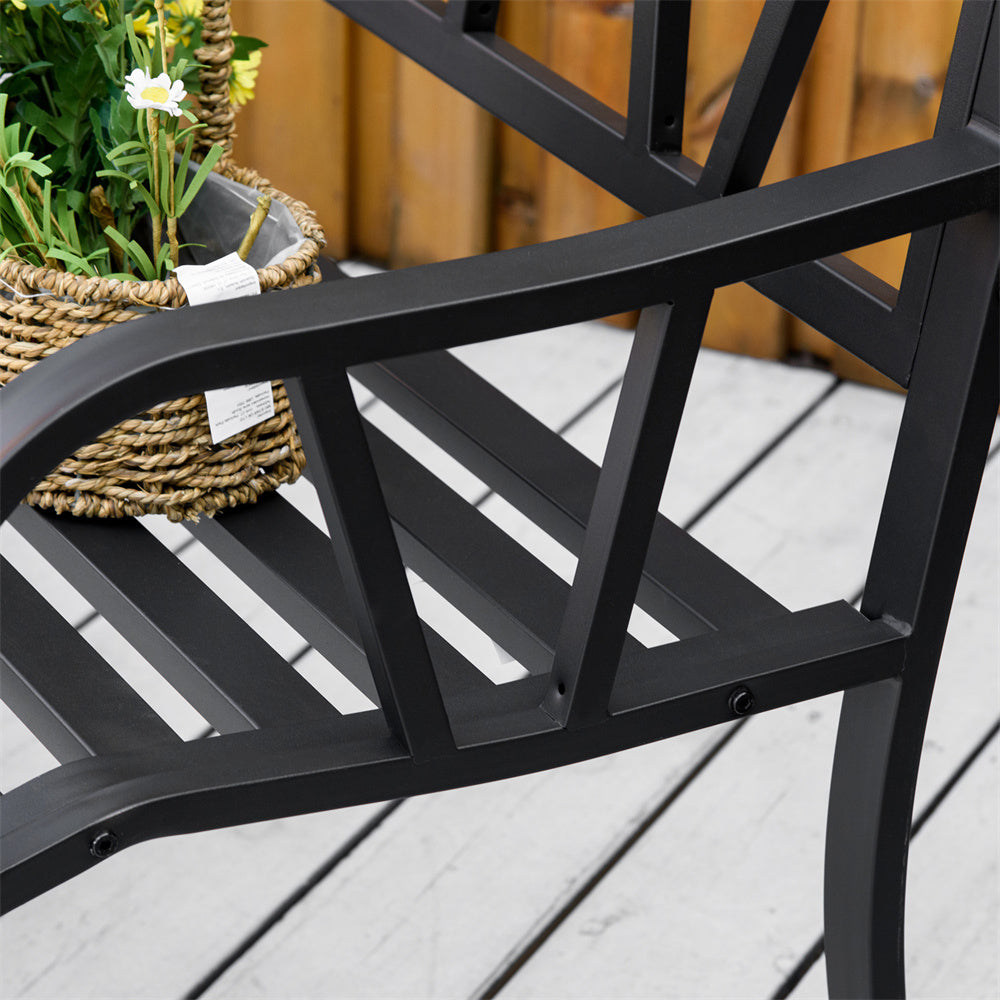 Black metal chair on a wooden deck with a plant in the background
