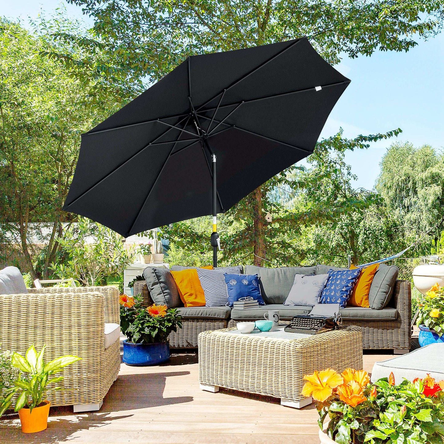 Black patio umbrella over an outdoor seating area with colourful cushions and plants.