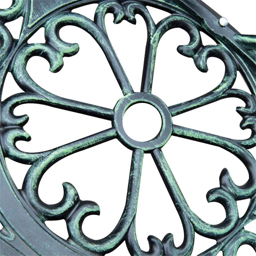 Close-up of a decorative metal plate with intricate green patina.