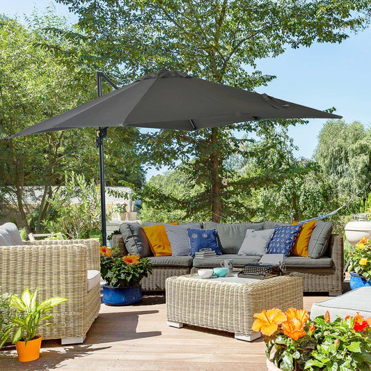 Outdoor patio with wicker furniture, umbrella, and potted plants on a wooden deck.