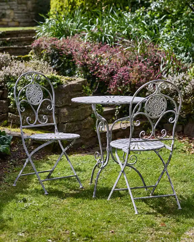 Vintage-style grey metal garden table and chairs.