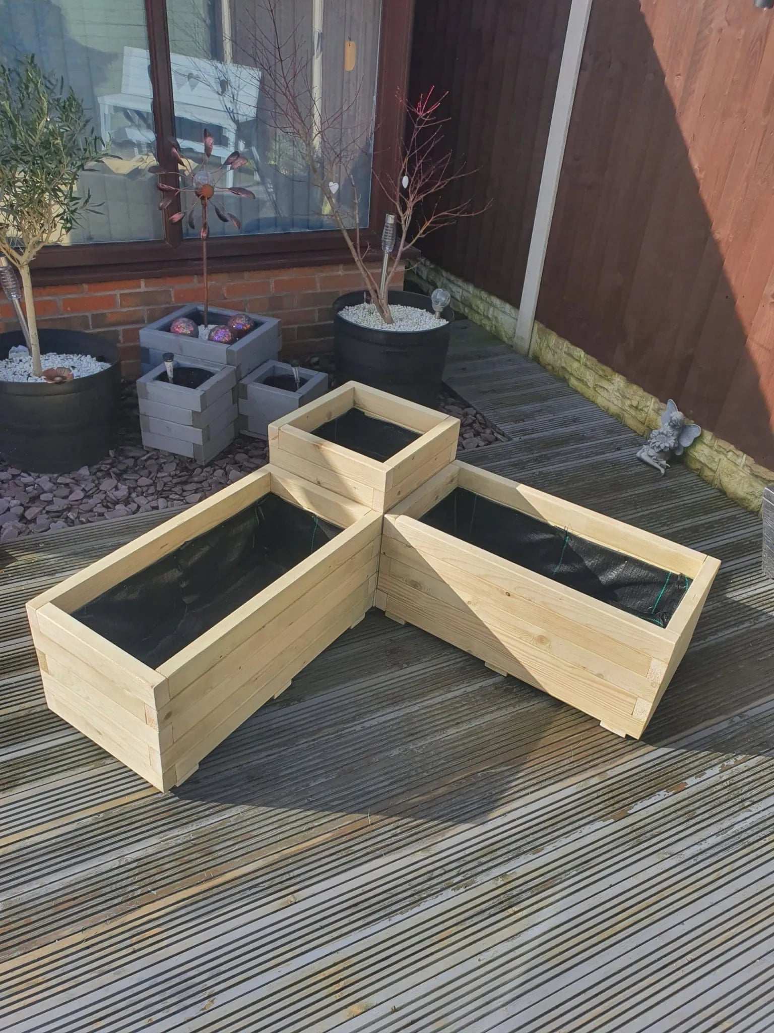 Large Corner Wooden Treated Garden Planter on decking area
