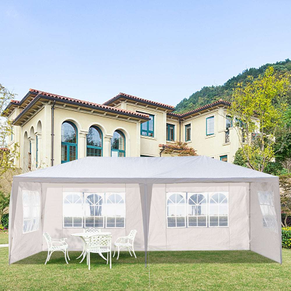White outdoor canopy tent with mesh walls in front of a large house.
