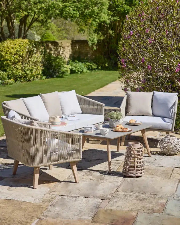 Comfortable outdoor patio set with wicker chairs and cushions 