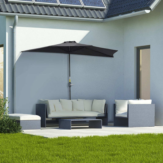 Outdoor patio set with a large umbrella on a patio area in front of a house.