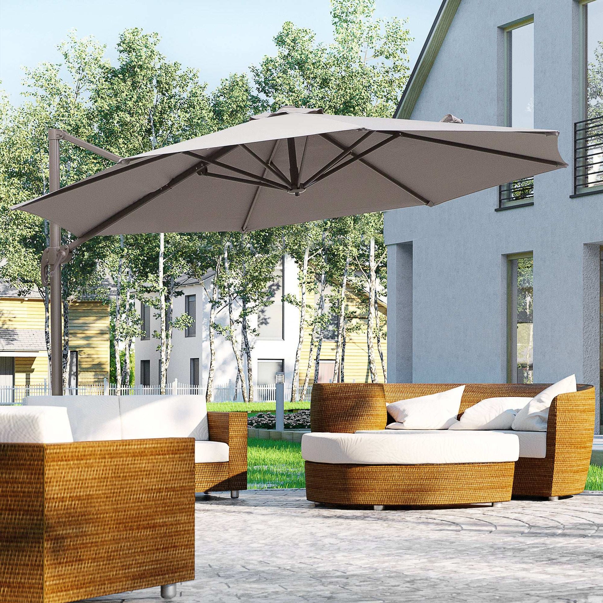Outdoor patio set with a large umbrella on a wooden deck, featuring wicker furniture and white cushions.