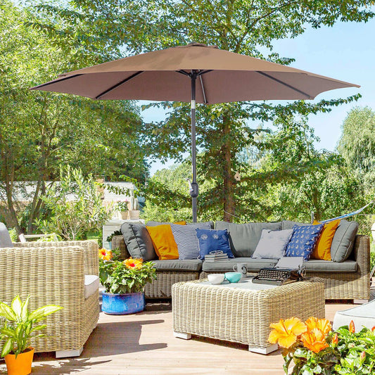 Outdoor patio with wicker furniture, umbrella, and decorative elements on a sunny day.