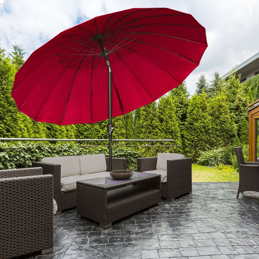Outdoor patio set with a red umbrella on a stone patio