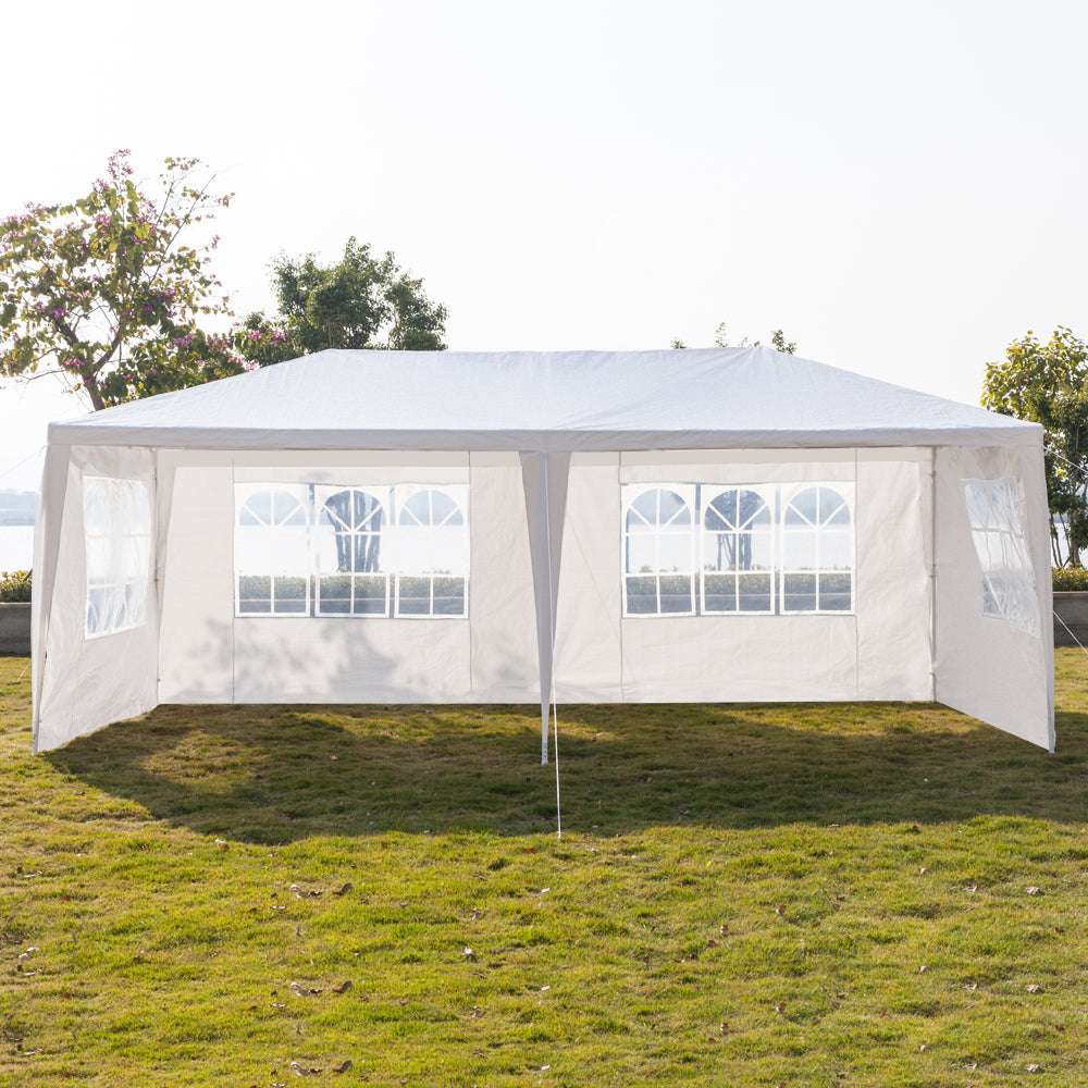 White outdoor canopy tent with clear side panels on a grassy area with trees in the background.