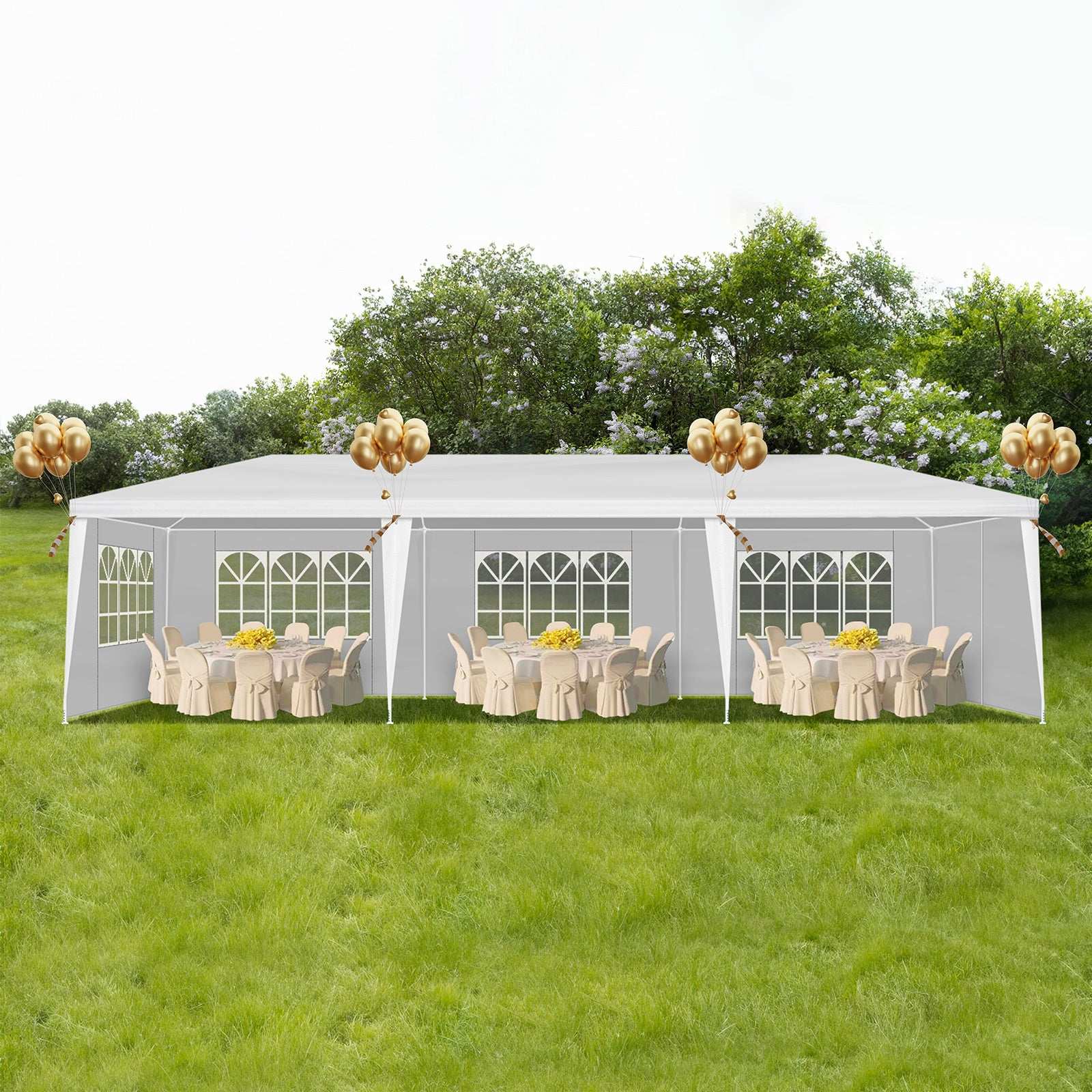 White party tent with tables and chairs under a clear sky