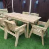Wooden outdoor furniture set with chairs and a table on a grassy area.