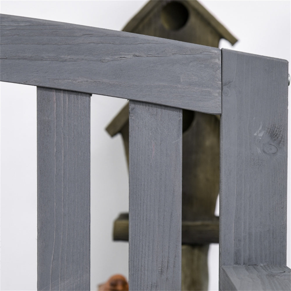 Wooden birdhouse attached to a wooden post with a blurred background
