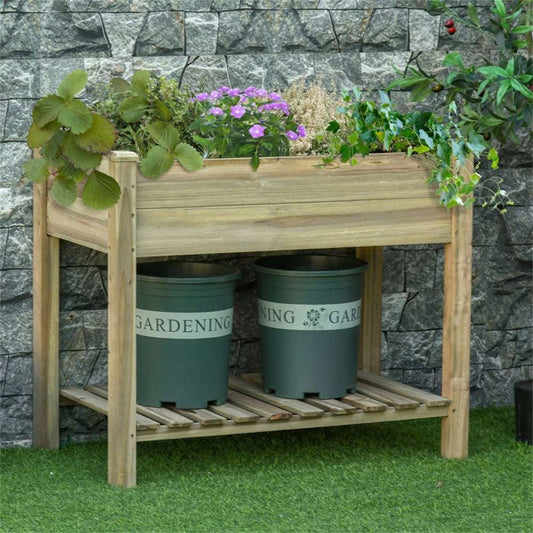 Wooden garden bench with planters and flowers against a stone wall.