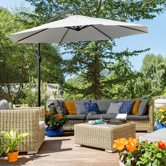 Outdoor patio with wicker furniture, cushions, and a large umbrella on a wooden deck.