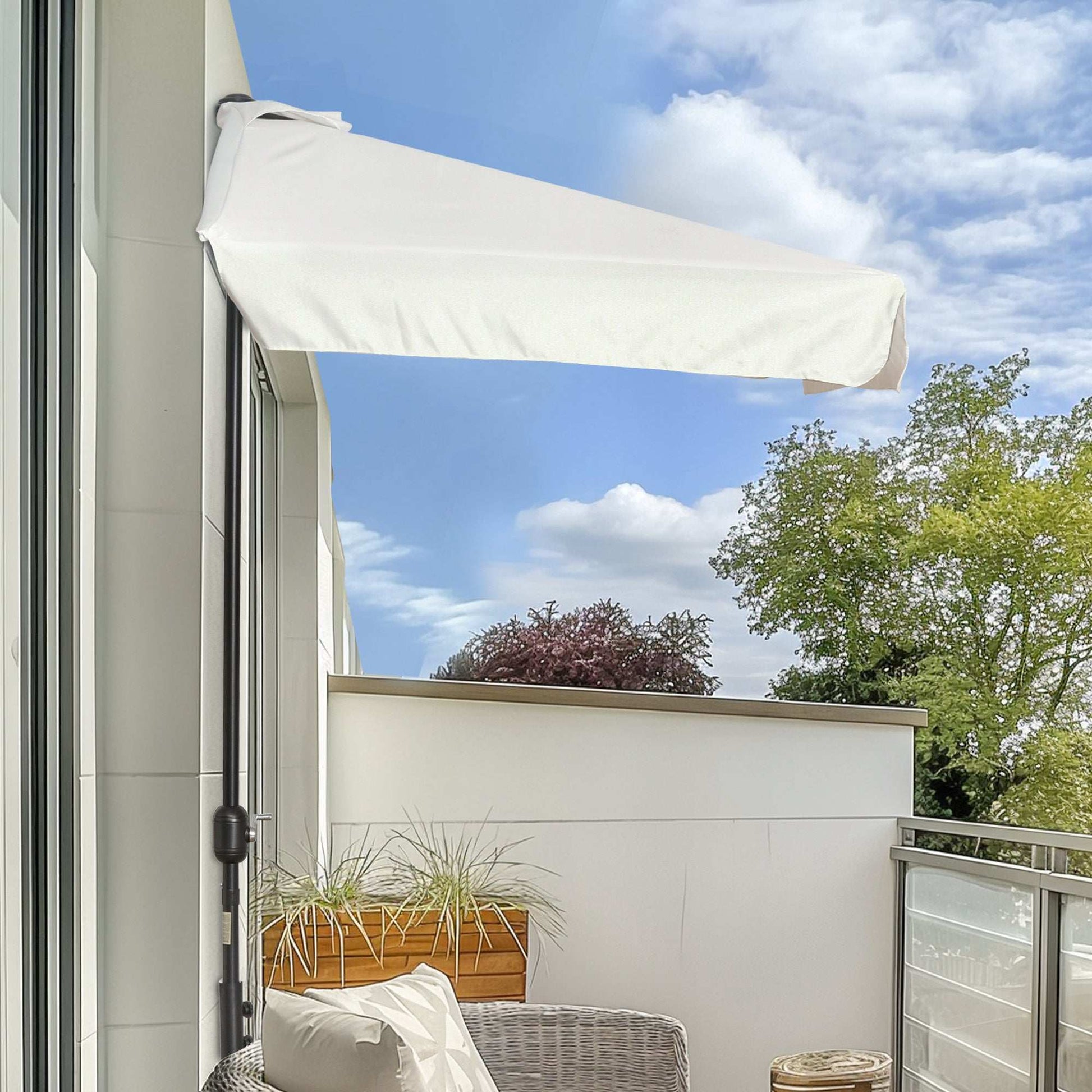 Balcony with a white retractable awning, plants, and a clear blue sky.